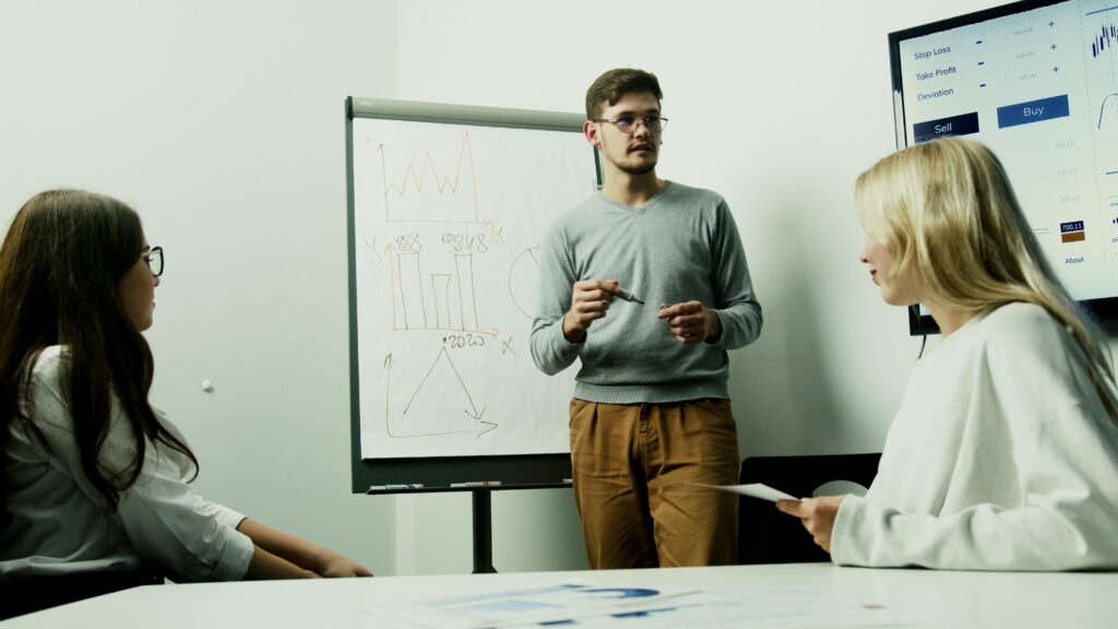 pexels photo 5716038 5716038 Adults discussing financial charts during a teamwork session.